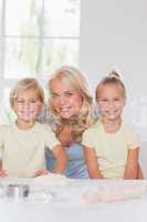 Family looking at the camera while baking