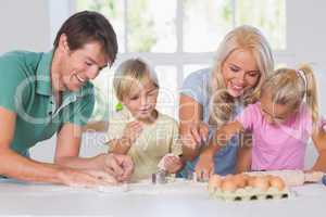 Family cutting the dough
