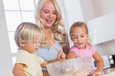 Children mixing the dough bowl with spoon