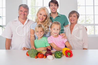 Family smiling with vegetables