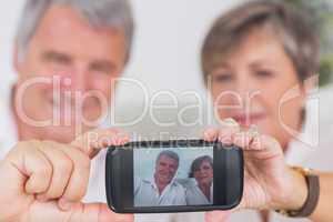 Old couple taking a picture of themselves