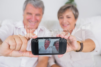 Old lovers taking a picture of themselves