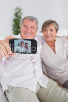 Old man taking a picture of him and his wife