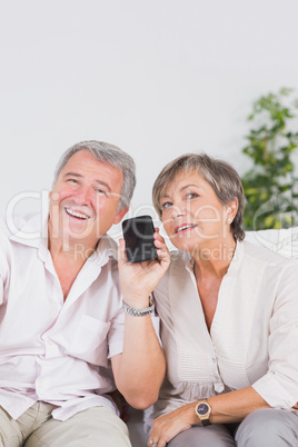 Old lovers listening to a smartphone