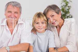 Portrait of a little boy and his grandparents smiling
