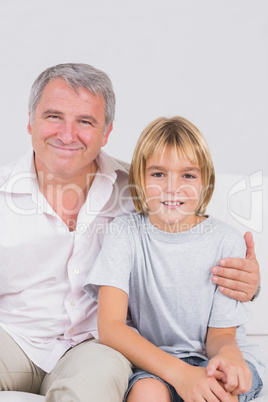 Portrait of a little boy and his grandfather smiling