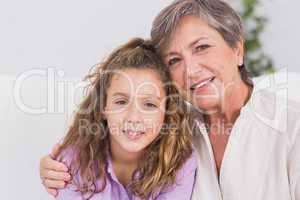 Portrait of a little girl and her grandmother smiling