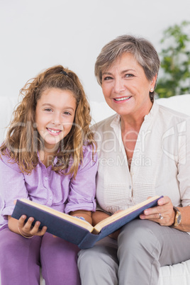 Little girl and her grandmother looking at the camera with a boo