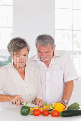 Elderly couple preparing vegetables