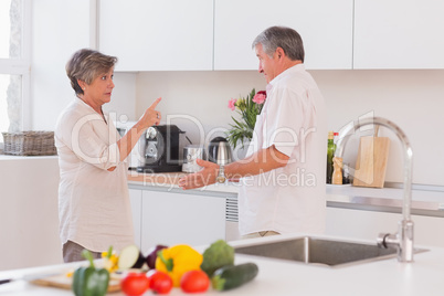 Old couple yelling in the kitchen