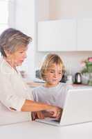 Granny and grandson looking at laptop