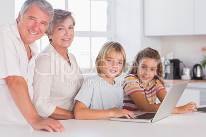 Grandparents and childrens looking at the camera together with l