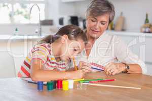 Child drawing with her grandmother