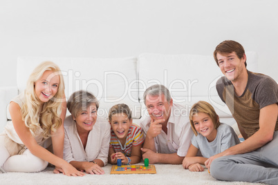 Family looking at the camera with board games