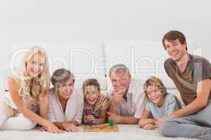 Family looking at the camera with board games