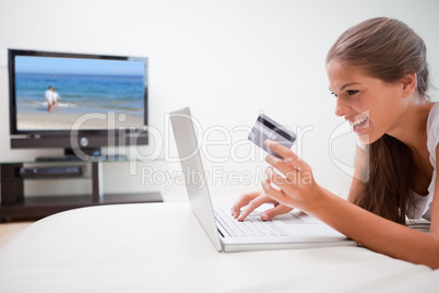 Woman in the living room shopping online