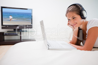 Woman listening to music on her laptop