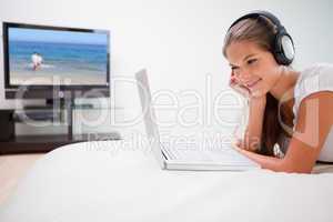 Woman listening to music on her laptop