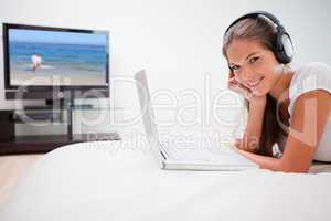 Woman listening to music on her notebook