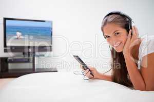 Smiling woman listening to music in the living room