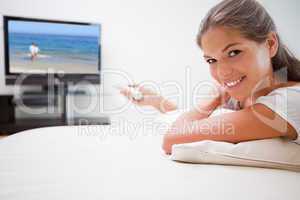 Smiling woman watching television