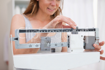 Woman adjusting scale