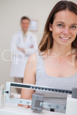 Smiling woman on the scale