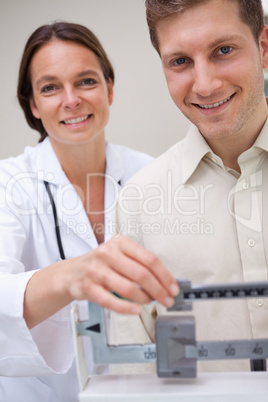 Doctor measuring patients weight