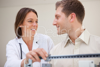 Doctor and patient talking about weight measuring