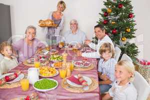 Mother bringing turkey to dinner table