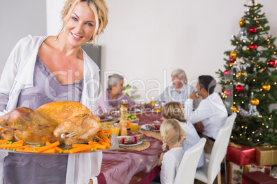 Proud mother showing roast turkey