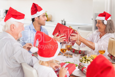 Happy family exchanging christmas gifts