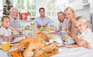 Focus on the roast turkey in front of family