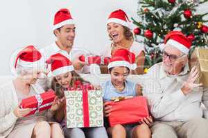 Excited family exchanging gifts at christmas