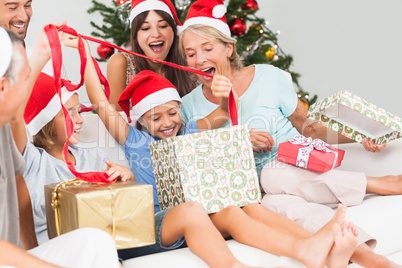 Happy family at christmas opening gifts together