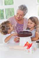 Children making cake with granny