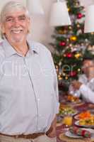 Happy grandfather standing at christmas