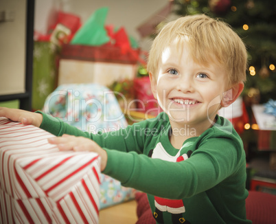 Young Boy Enjoying Christmas Morning Near The Tree