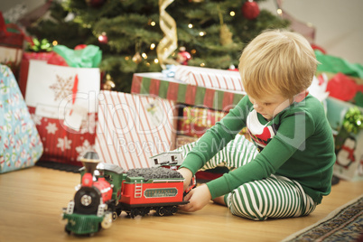 Young Boy Enjoying Christmas Morning Near The Tree