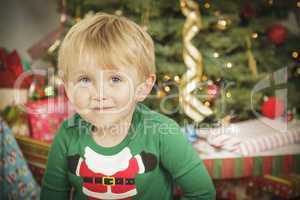 Young Boy Enjoying Christmas Morning Near The Tree