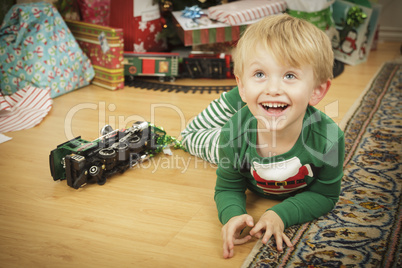 Young Boy Enjoying Christmas Morning Near The Tree