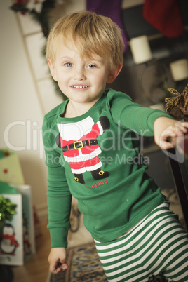 Young Boy Enjoying Christmas Morning Near The Tree