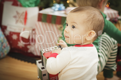 Infant Baby Enjoying Christmas Morning Near The Tree