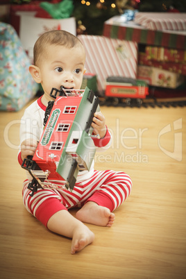 Infant Baby Enjoying Christmas Morning Near The Tree