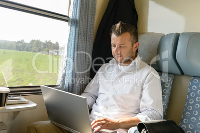 Man commuting with train using laptop travel