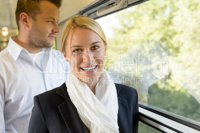 Woman smiling in train man selective focus