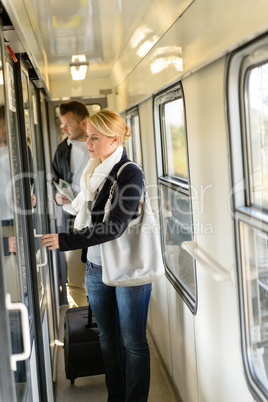 Woman opening the  door of train compartment