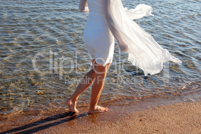 Walking by sea on sand