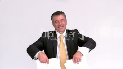 Happy businessman launching papers