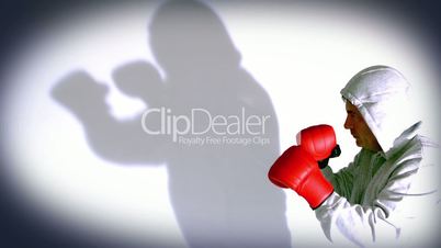 Man boxing and with shadow on the wall